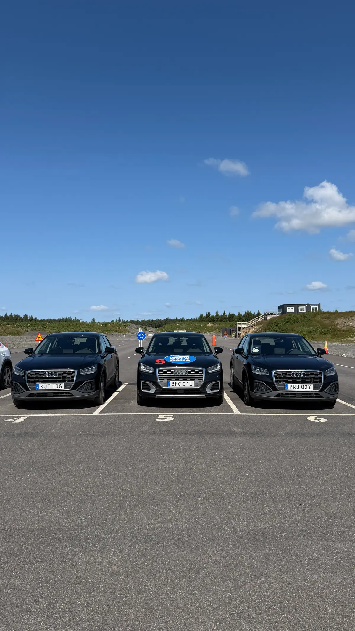 Three dark training cars from the front on the track in Landvetter